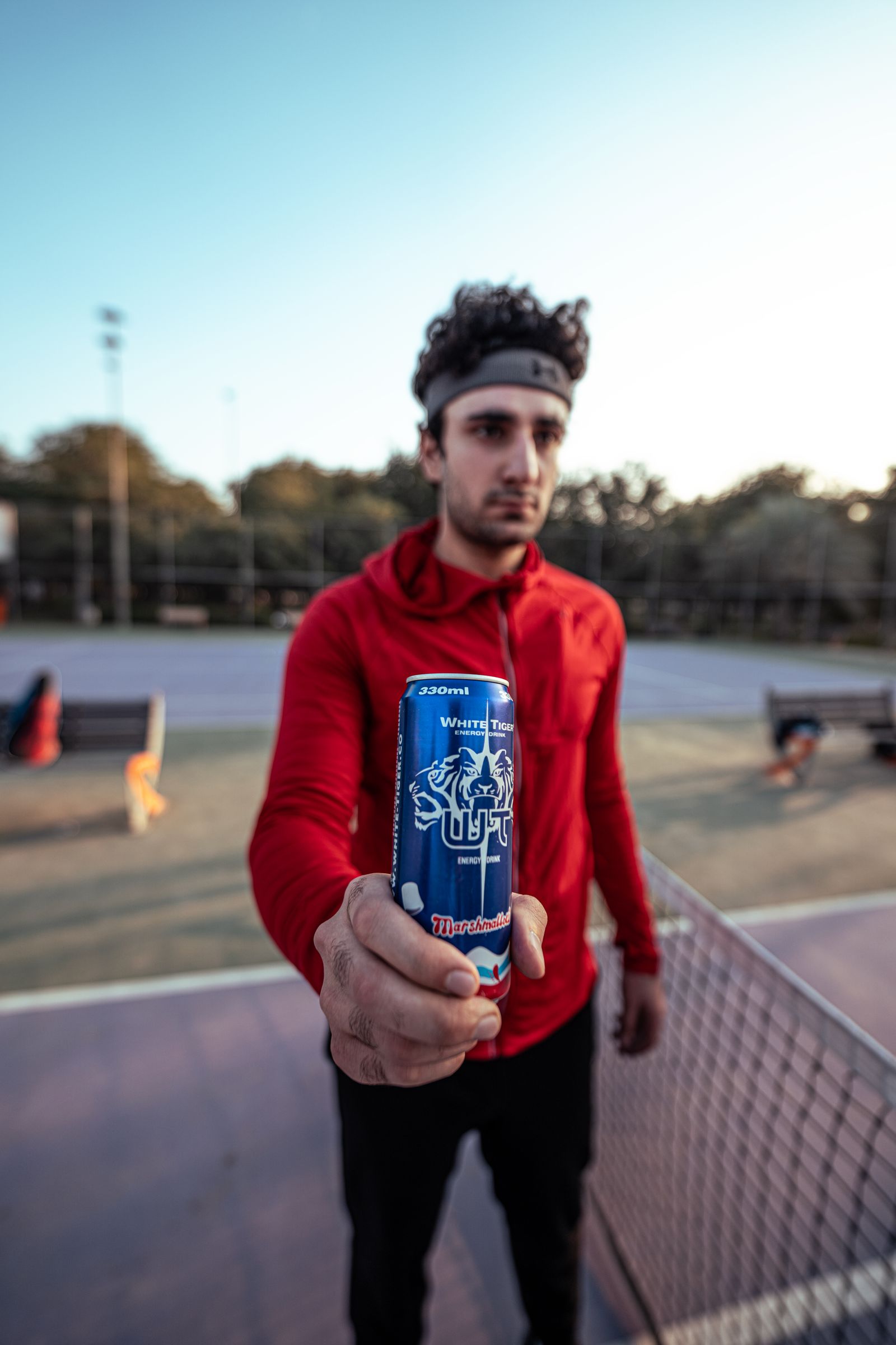 An active person holding a clean energy drink before training.