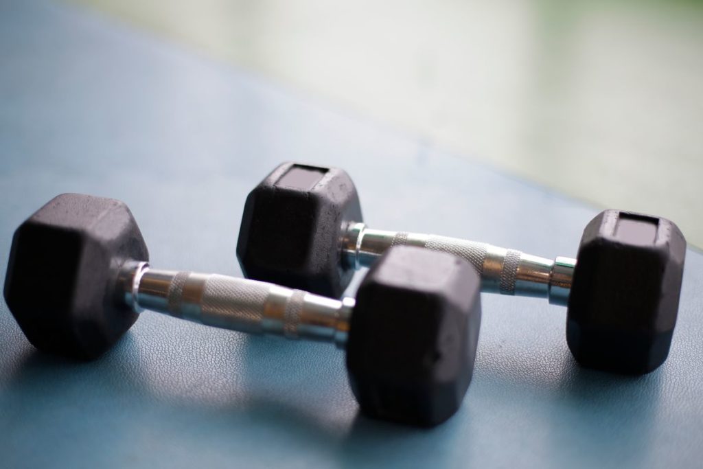 A rack of hex dumbbells, the tool of higher-volume hypertrophy training
