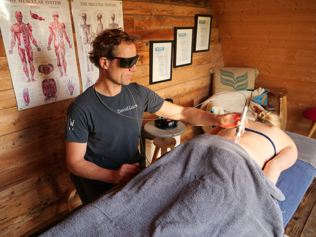 David Lucas using K-Laser therapy on a client in his studio