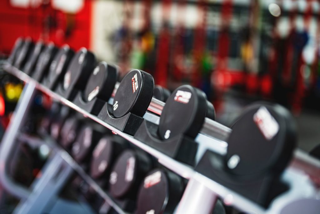 A rack of dumbbells lined up in a gym