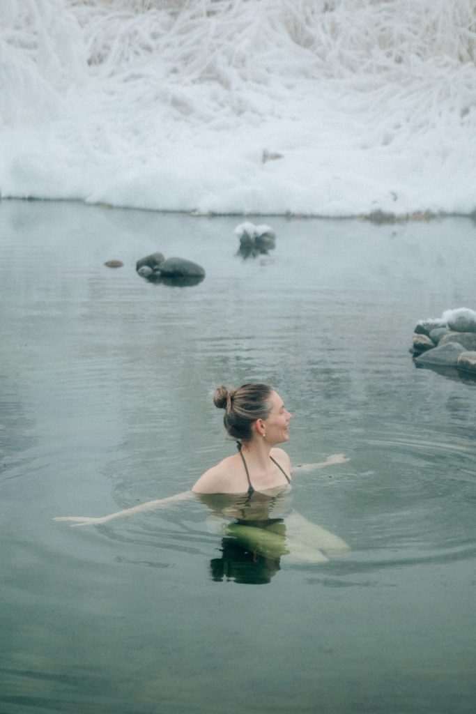 A woman immersed calmly in cold open water